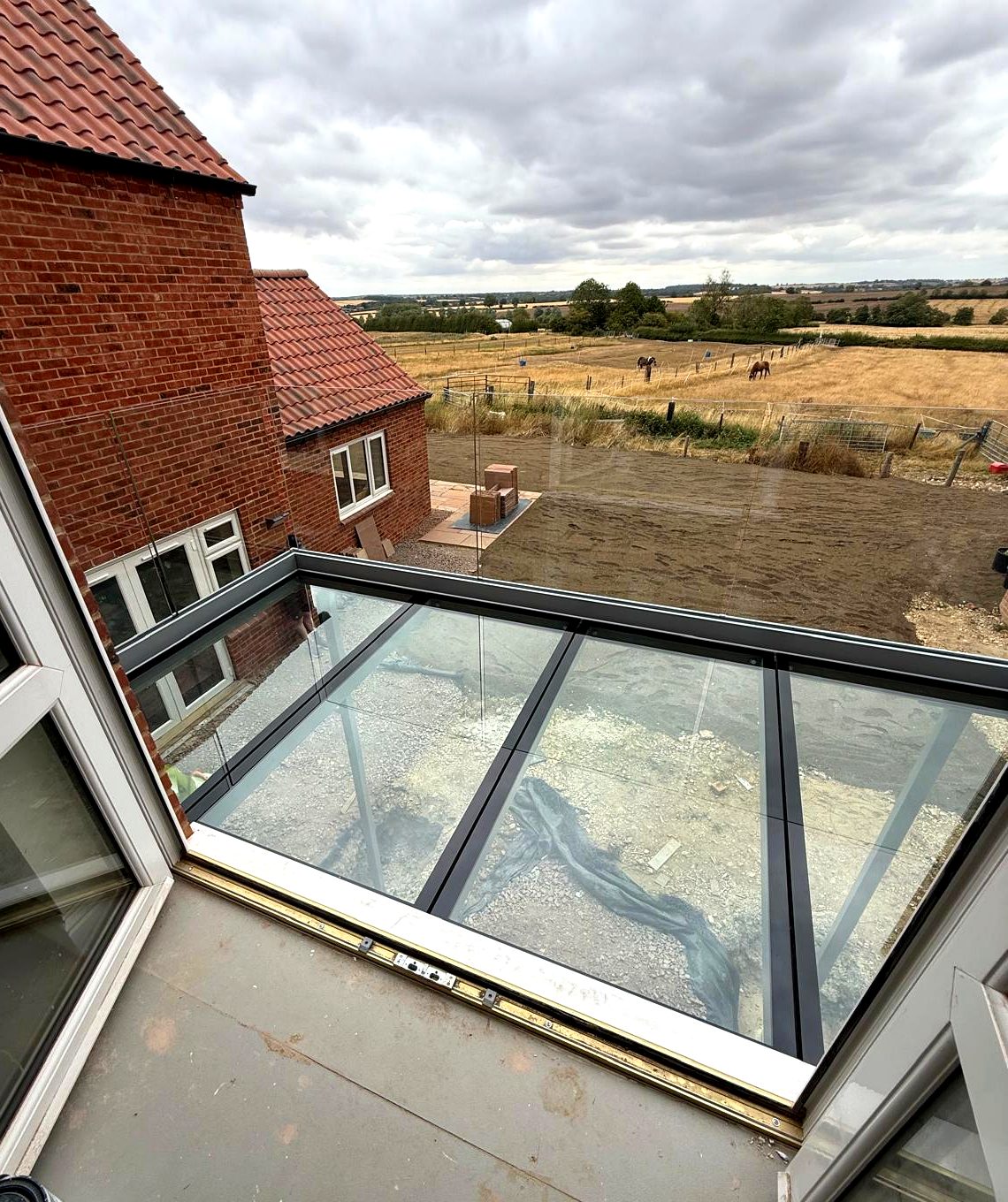 Structural walk-on glass floor panels with 50mm painted borders on a balcony, Rutland